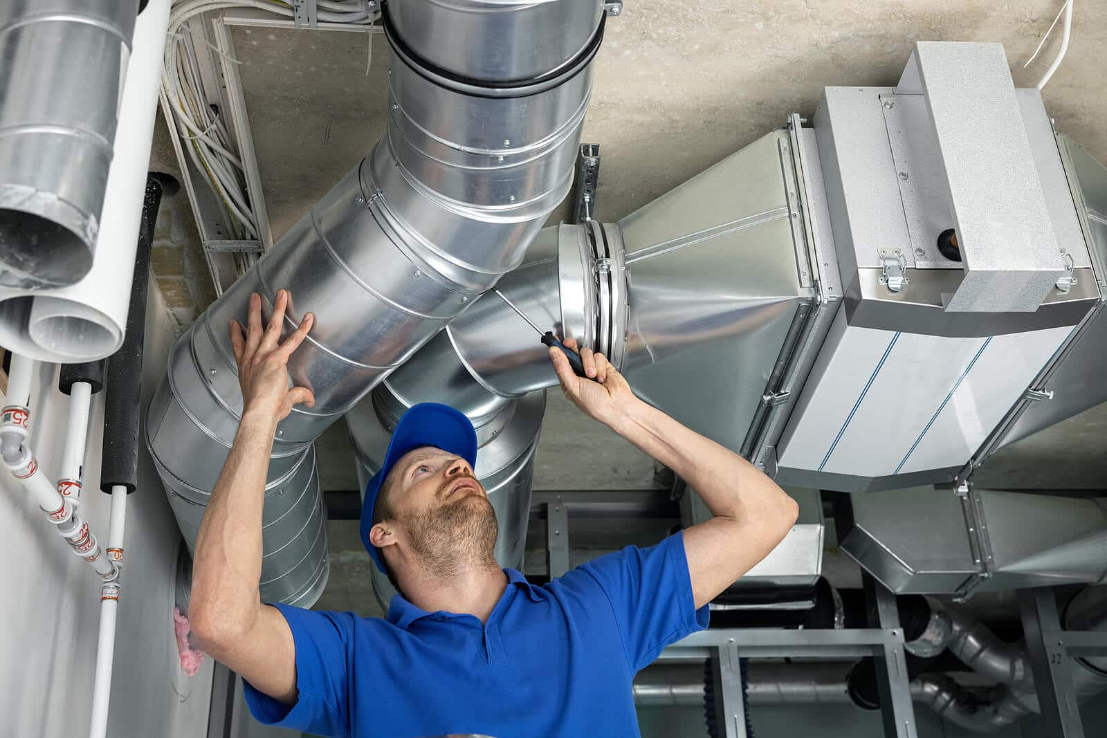 HVAC technician inspecting and repairing air ducts in San Rafael