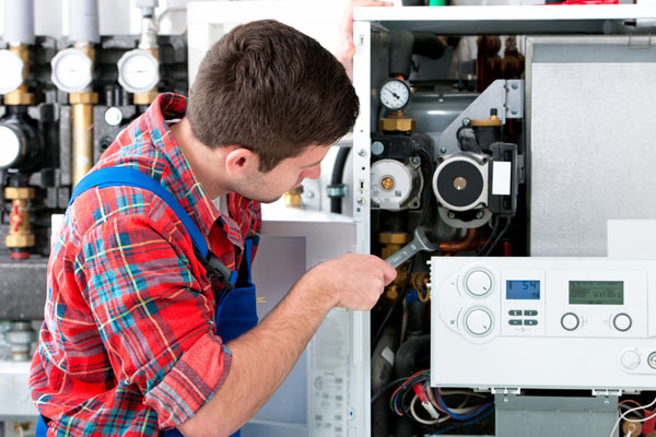 Heating technician repairing boiler controls in San Rafael