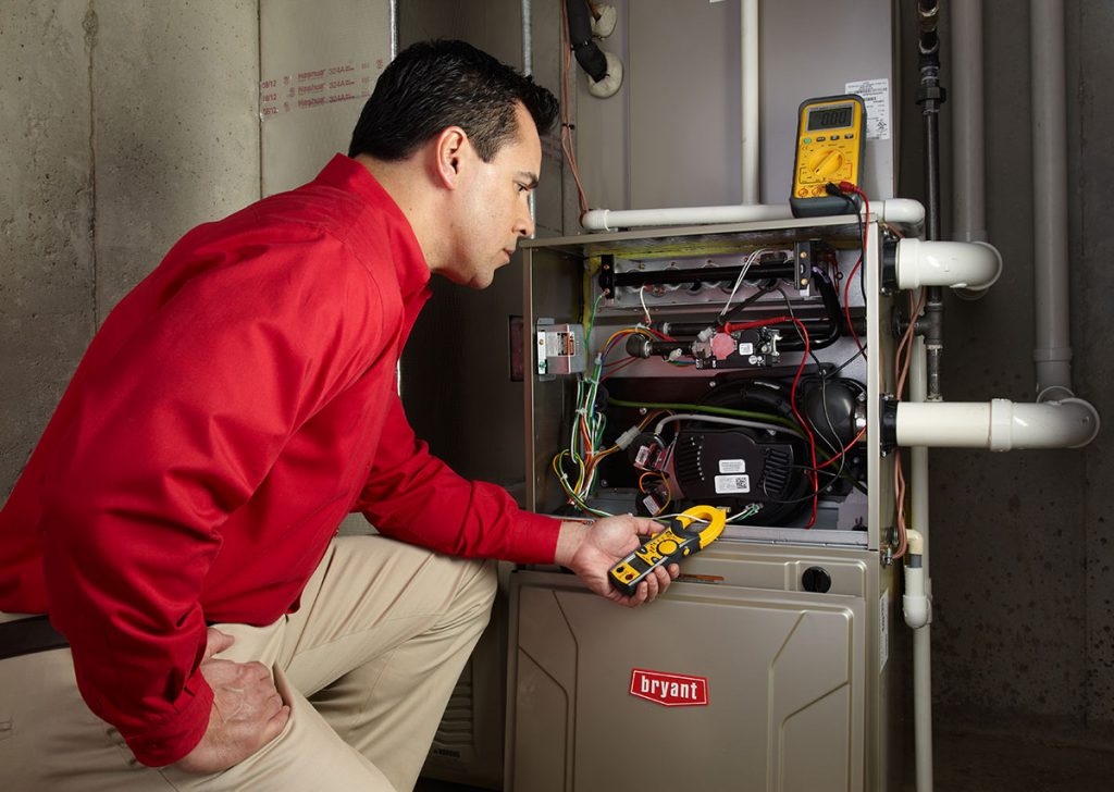 Heating technician diagnosing a furnace repair in San Rafael