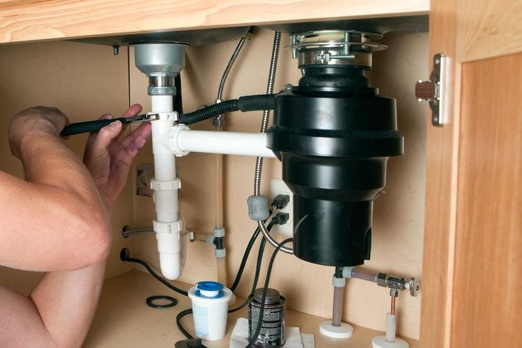 Plumber repairing a garbage disposal in San Rafael