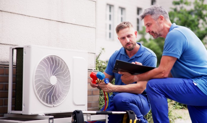 HVAC technicians installing an outdoor air conditioning unit in San Rafael