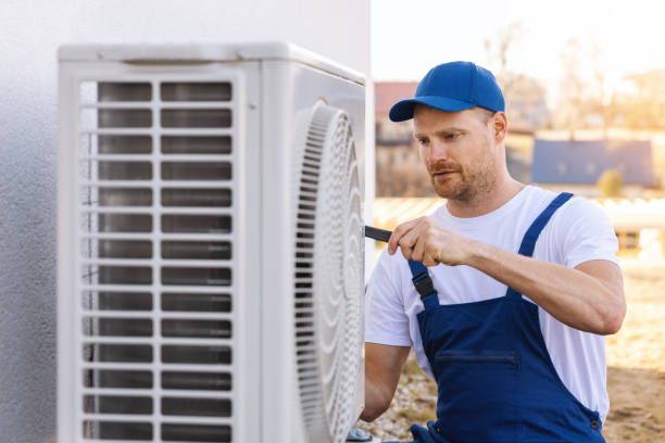 HVAC technician servicing an outdoor air conditioner in San Rafael