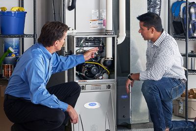 Technician evaluating a furnace for repair or replacement in San Rafael Plumbing and Air Pros