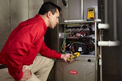 Heating technician diagnosing a furnace repair in San Rafael