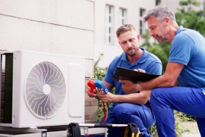 HVAC technicians installing an outdoor air conditioning unit in San Rafael Plumbing and Air Pros
