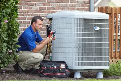 HVAC technician inspecting an outdoor AC unit in San Rafael